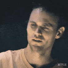 a man covering his face with his hand with netflix written on the bottom right