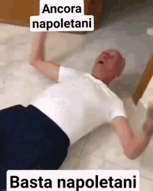a man is laying on the floor with the words ancora napoletani and basta napoletani above him