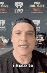 a man says i hate to in front of a pop culture weekly banner