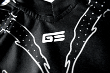 a black shirt has a white g on the front