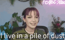a woman wearing headphones is sitting in front of a microphone .