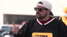 a man wearing sunglasses and a black shirt that says imdb
