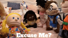 a bunch of stuffed dolls sitting on a bed with the words excuse me on the bottom