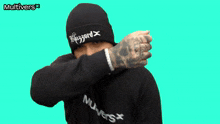 a man wearing a beanie and a hoodie that says multivers on it