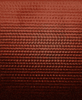 a close up of a red knitted pattern on a dark background
