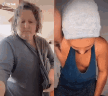 a woman in a gray shirt and a woman in a blue tank top are both standing next to each other .