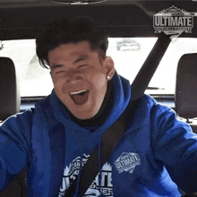 a man wearing a blue jacket that says canada 's ultimate challenge on it