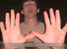 a man 's hands are visible in front of a glass