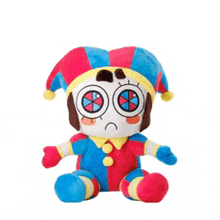 a stuffed clown with a sad face is sitting on a white background