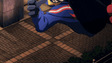 a man in a blue red and yellow jacket is flying through the air on a brick sidewalk