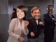 a woman and two men are dancing in a room