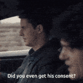 a man in a suit is talking to another man in a car with the words did you even get his consent behind him