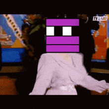 a person with a purple square on their head is sitting in front of a tv screen