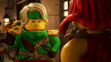 a lego figure with a green scarf around his neck is standing next to another lego figure
