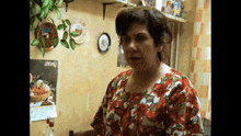 a woman stands in front of a calendar that says 2010 on it