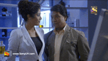 a man and a woman are standing next to each other in a sony television ad