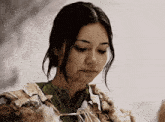 a woman is wearing a fur coat and a green shirt