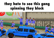 they hate to see this gang spinning they block with a group of people standing on top of a blue car