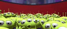 a bunch of toy story aliens are standing next to each other on a red background
