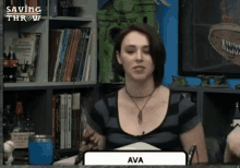 a woman is sitting at a table with the name ava on the screen