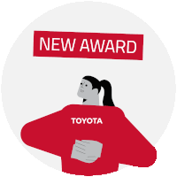 a woman in a toyota shirt is holding a trophy over a sign that says new award