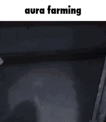 a person is standing in a dark room with the words aura farming on the bottom of the screen .