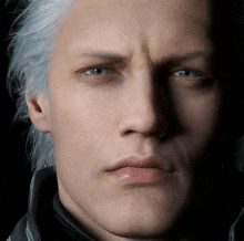 a close up of a man 's face with blue eyes