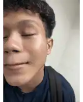 a close up of a man 's face with his eyes closed and his mouth open