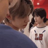 a man wearing a t-shirt that says lb on it