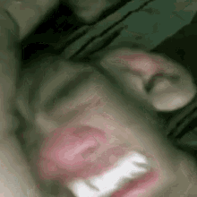 a close up of a person 's face with their mouth open and their teeth visible .