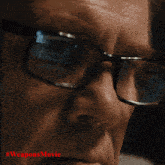 a close up of a man wearing glasses with the words #weaponsmovie below him