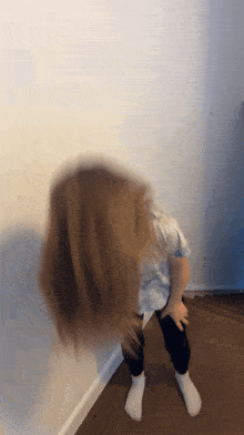 a blurry picture of a little girl with her hair blowing in the air