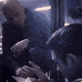 a man in a suit is talking to another man