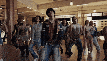 a group of people are dancing in a room and one of them is wearing a jacket that says ' simpson ' on it