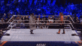 two wrestlers in a wrestling ring with a aew banner behind them