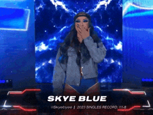 a female wrestler named skye blue is covering her mouth with her hand