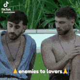 two shirtless men are sitting next to each other with the words enemies to lovers above them