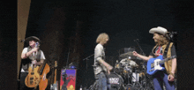 a band on stage with a drum that says smic