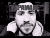 a man with a beard is smiling in a black and white photo with papamace written on the top