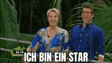 a man and a woman are standing next to each other in front of a sign that says ich bin ein star