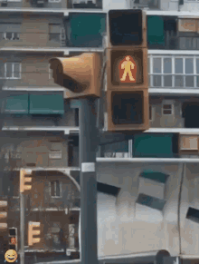 a pedestrian crossing light with a yellow man on it