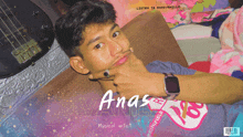 a musical artist named anas is laying on a couch with a guitar in the background