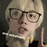 a woman wearing glasses has the words erm ackshually written on her face