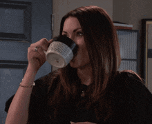 a woman is drinking from a mug that says " i love you " on it