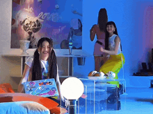 a girl sitting on a couch with a laptop with stickers on it that says " i love you "