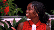 a woman in a red dress is holding a tube of old spice lotion