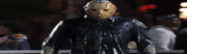 a man in a jason voorhees mask is standing in a dark room .