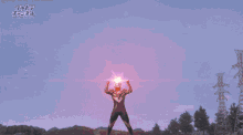 a man is standing in front of a large explosion with the word ultra on the bottom left