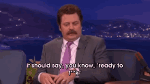 a man in a suit and tie is saying " it should say you know "