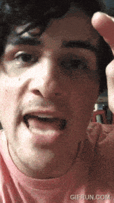 a close up of a man 's face with the website gifrun.com visible in the corner
